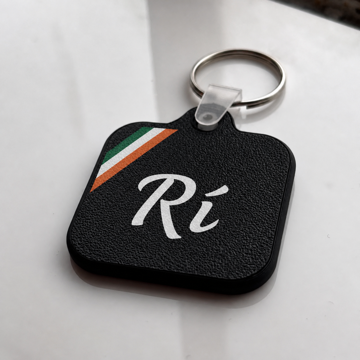 Black Rí keychain with a metal ring.